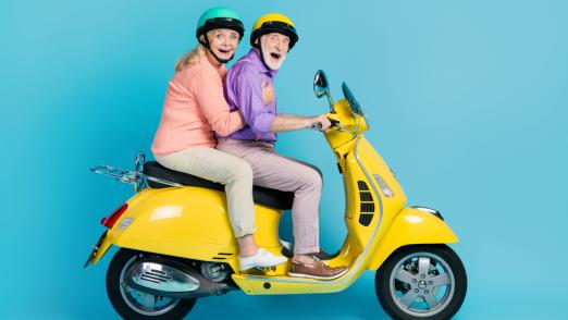 Full size profile side photo of happy cheerful old couple ride bike journey isolated on pastel blue color background