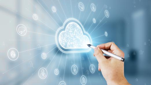 Close up of male hand with pen pointing at digital white cloud hologram with various icons on blurry office interior background. Cloud computing and storage server concept