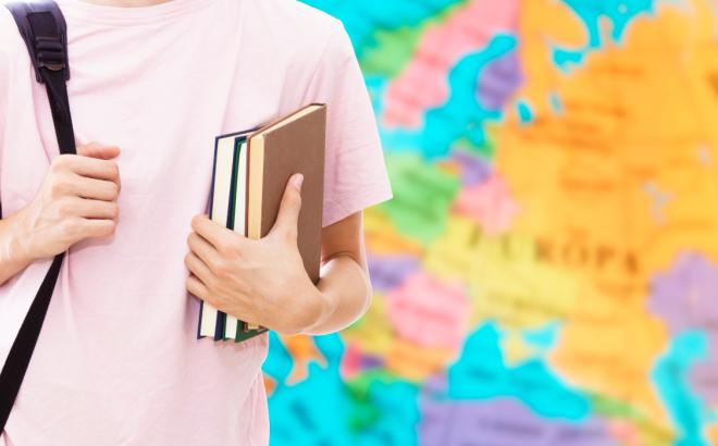 student hand with books and map, learn languages